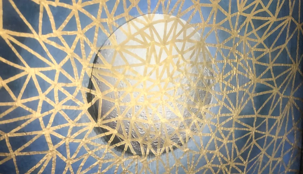 A golden geometric lattice over deep blue, around a pale glowing circle